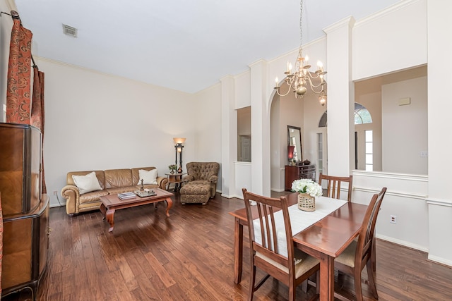 6249 Mallard Dr, Katy, TX 77493 - dining area with arched walkways, visible vents, dark wood-style floors, and an inviting chandelier
