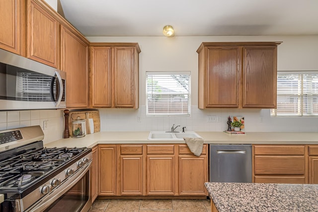 6249 Mallard Dr, Katy, TX 77493 - kitchen with decorative backsplash, a wealth of natural light, stainless steel appliances, and a sink