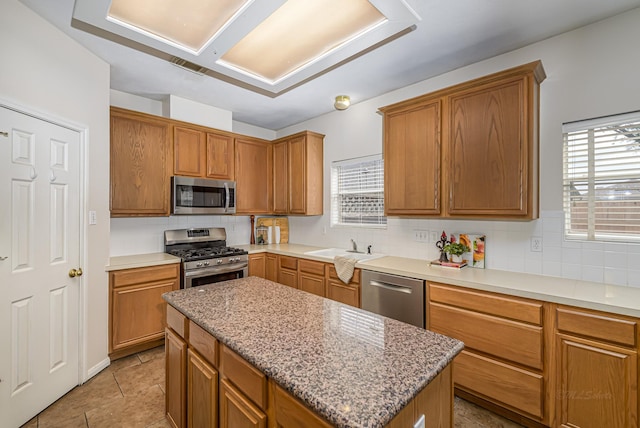 6249 Mallard Dr, Katy, TX 77493 - kitchen featuring decorative backsplash, a wealth of natural light, stainless steel appliances, and a sink