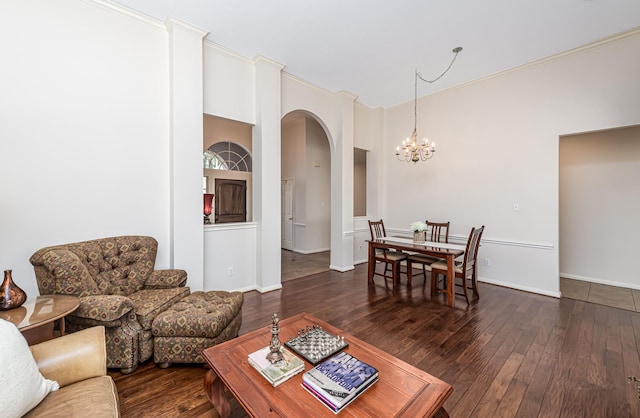 6249 Mallard Dr, Katy, TX 77493 - living room featuring baseboards, arched walkways, a chandelier, and wood-type flooring