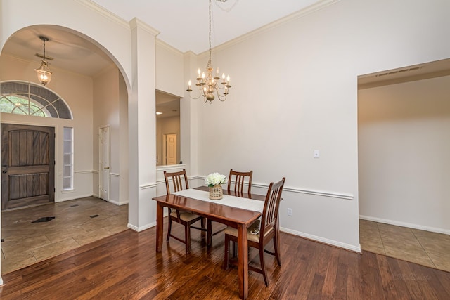 6249 Mallard Dr, Katy, TX 77493 - dining space featuring arched walkways, crown molding, a chandelier, and wood finished floors
