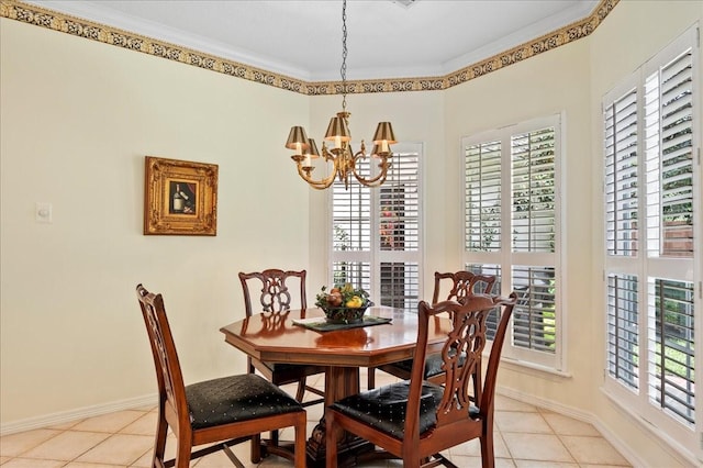 dining area featuring ornamental molding, light tile patterned floors, a chandelier, and baseboards