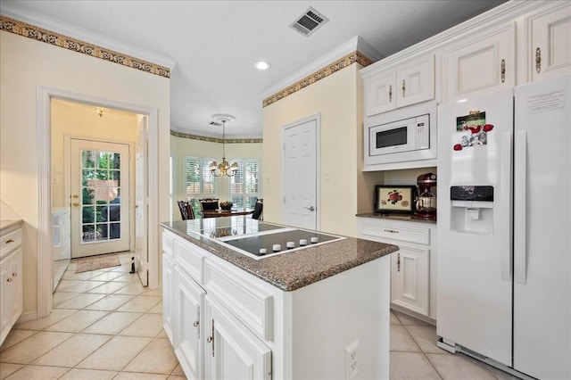 kitchen featuring light tile patterned floors, a notable chandelier, visible vents, white appliances, and ornamental molding
