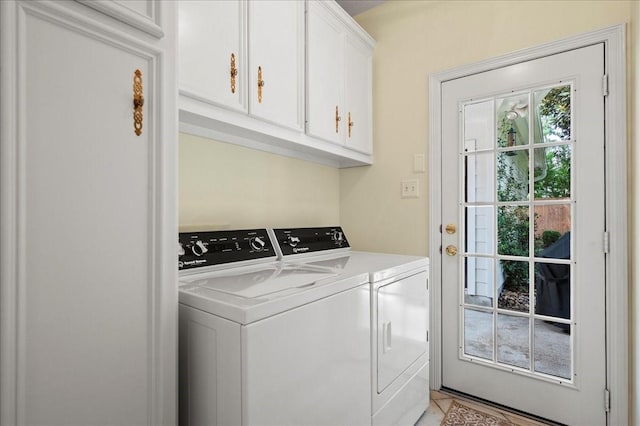 laundry room featuring independent washer and dryer and cabinet space