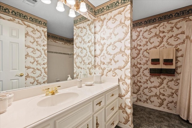 bathroom featuring visible vents, wallpapered walls, baseboards, toilet, and vanity