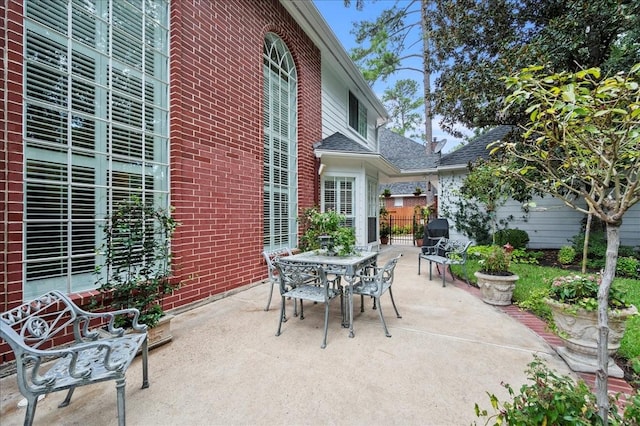 view of patio / terrace featuring fence and outdoor dining area