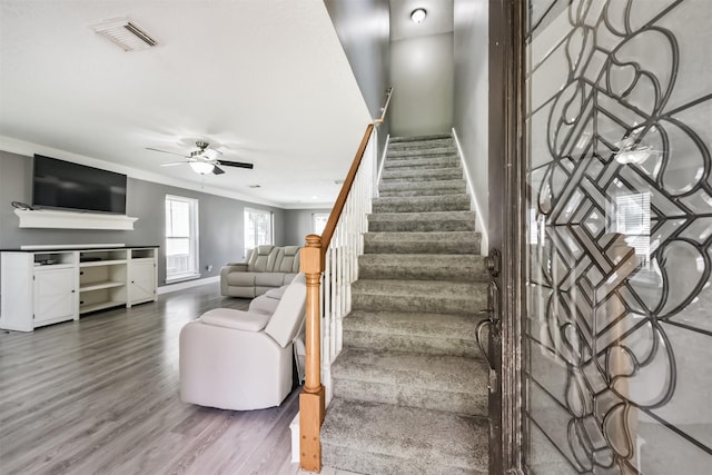 3626 Lake Breeze Ln, Crosby, TX 77532 - staircase with baseboards, visible vents, wood finished floors, ceiling fan, and ornamental molding
