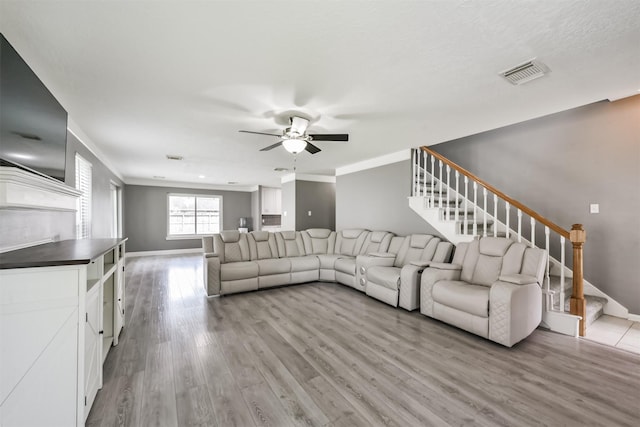 3626 Lake Breeze Ln, Crosby, TX 77532 - living area featuring stairway, visible vents, baseboards, and ceiling fan