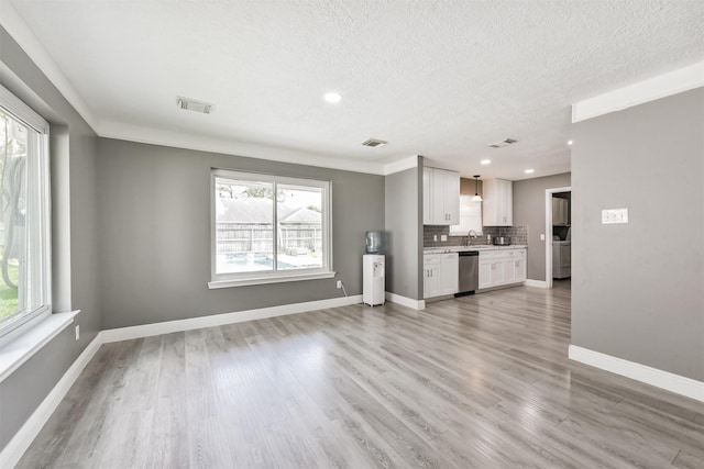 3626 Lake Breeze Ln, Crosby, TX 77532 - unfurnished living room with visible vents, a sink, and light wood-style floors