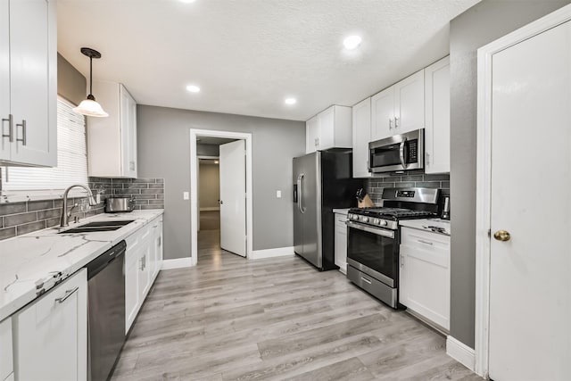 3626 Lake Breeze Ln, Crosby, TX 77532 - kitchen featuring white cabinets, decorative backsplash, stainless steel appliances, and a sink