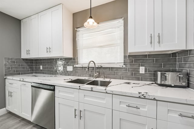 3626 Lake Breeze Ln, Crosby, TX 77532 - kitchen with a sink, tasteful backsplash, white cabinetry, light stone countertops, and dishwasher