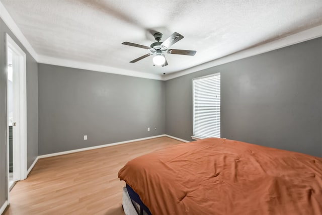 3626 Lake Breeze Ln, Crosby, TX 77532 - bedroom with baseboards, a ceiling fan, light wood-style floors, and a textured ceiling