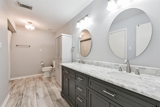 3626 Lake Breeze Ln, Crosby, TX 77532 - full bathroom with double vanity, visible vents, toilet, and a sink