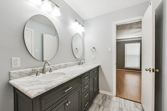 3626 Lake Breeze Ln, Crosby, TX 77532 - bathroom with baseboards, marble finish floor, a sink, and double vanity
