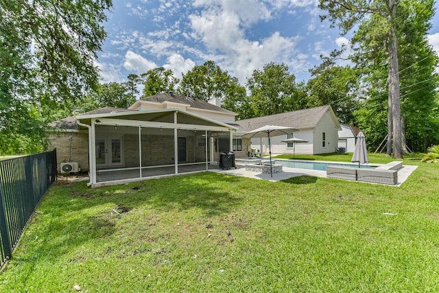 3626 Lake Breeze Ln, Crosby, TX 77532 - back of property featuring french doors, an outdoor pool, a yard, a sunroom, and a patio