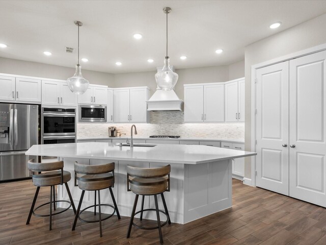7262 Monarch Dr, Katy, TX 77493 - kitchen featuring appliances with stainless steel finishes, decorative backsplash, a sink, and dark wood-type flooring