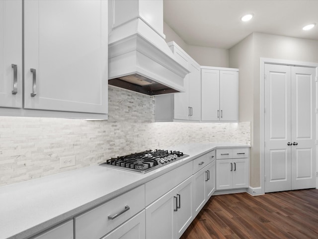 7262 Monarch Dr, Katy, TX 77493 - kitchen featuring decorative backsplash, dark wood-style flooring, custom exhaust hood, light countertops, and stainless steel gas stovetop