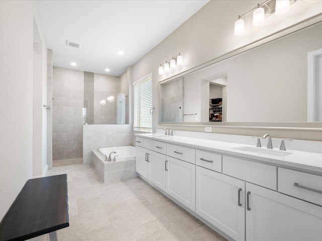 7262 Monarch Dr, Katy, TX 77493 - full bath with double vanity, a garden tub, walk in shower, a sink, and tile patterned floors
