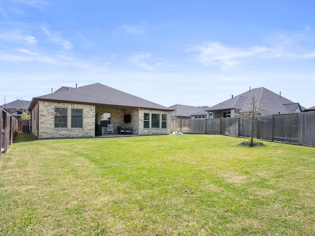 7262 Monarch Dr, Katy, TX 77493 - back of house with brick siding, a fenced backyard, a patio area, and a yard