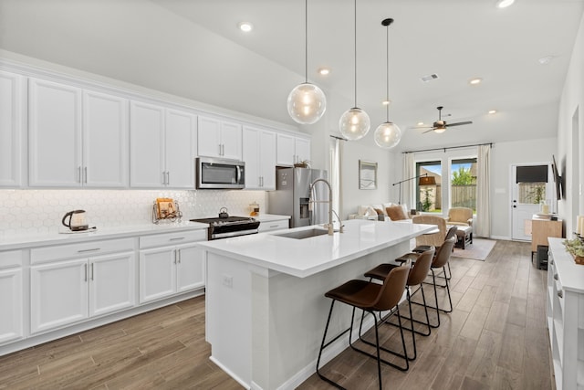 21131 Austin Chalk Dr, Cypress, TX 77433 - kitchen featuring white cabinets, ceiling fan, and stainless steel appliances