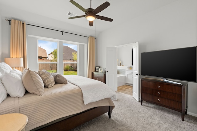 21131 Austin Chalk Dr, Cypress, TX 77433 - bedroom with light carpet, ensuite bath, visible vents, and a ceiling fan