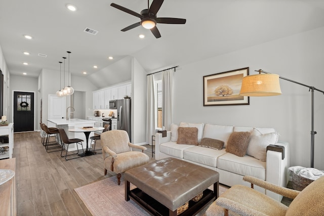 21131 Austin Chalk Dr, Cypress, TX 77433 - living area featuring vaulted ceiling, a ceiling fan, light wood-style floors, visible vents, and recessed lighting