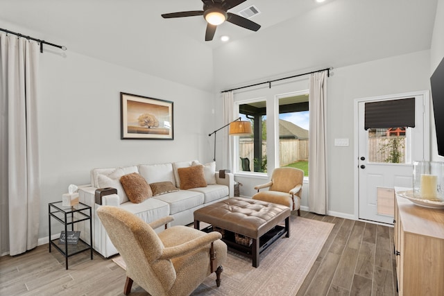 21131 Austin Chalk Dr, Cypress, TX 77433 - living room with light wood finished floors, vaulted ceiling, visible vents, baseboards, and ceiling fan