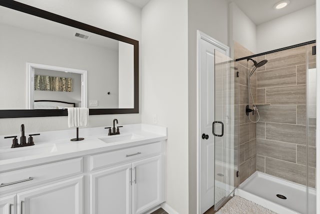 21131 Austin Chalk Dr, Cypress, TX 77433 - full bath featuring double vanity, a shower stall, visible vents, and a sink