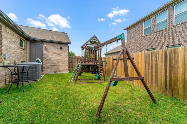 view of play area with cooling unit, a lawn, and a fenced backyard