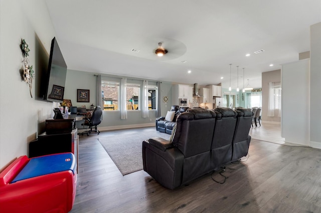 living area with plenty of natural light, baseboards, and ceiling fan