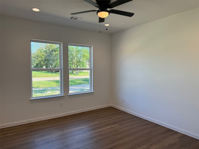 empty room with a ceiling fan, baseboards, dark wood-style flooring, visible vents, and recessed lighting