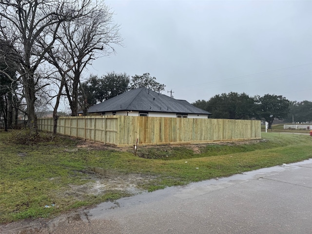 view of side of property featuring fence