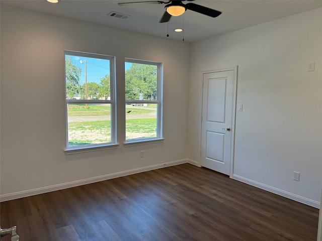 empty room with dark wood-style floors, visible vents, baseboards, recessed lighting, and a ceiling fan