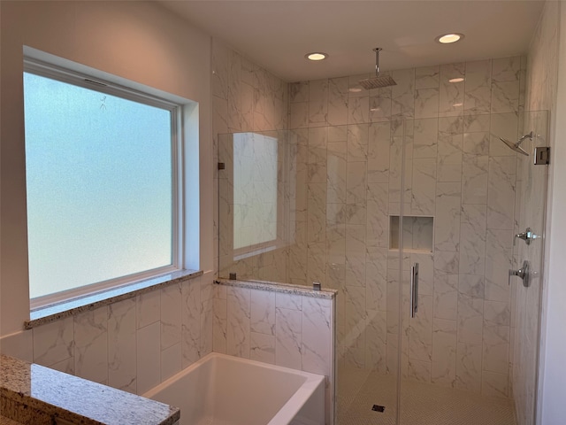bathroom with a garden tub, recessed lighting, and a stall shower