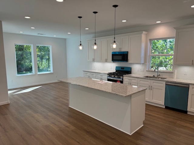 kitchen featuring backsplash, dishwashing machine, a sink, black microwave, and gas range