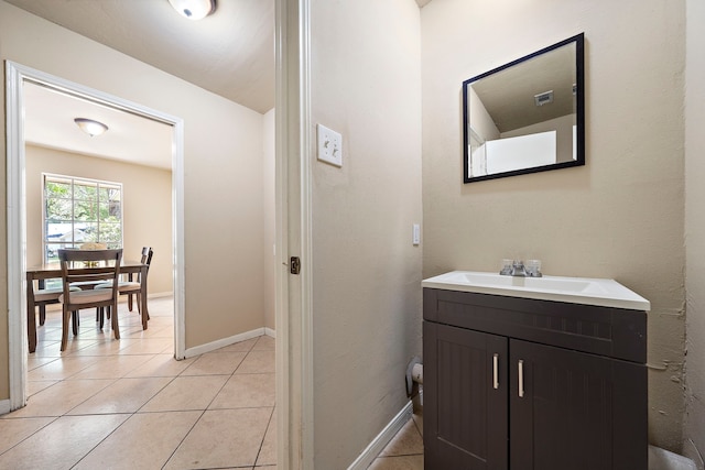 bathroom featuring baseboards, tile patterned flooring, and vanity