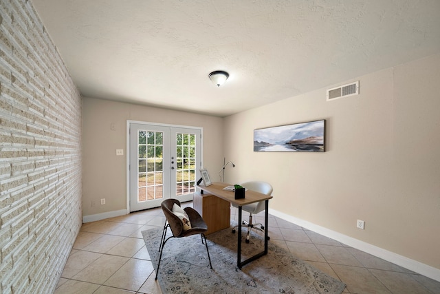 office featuring light tile patterned flooring, visible vents, baseboards, and french doors