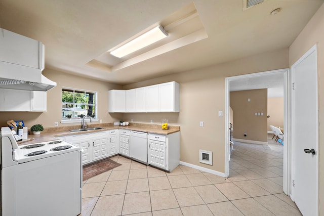 kitchen with light countertops, white appliances, a sink, and light tile patterned floors