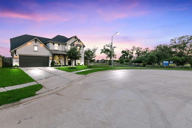 19219 Filly Park Cir, Tomball, TX 77377 - view of front of home with driveway, a standing seam roof, stucco siding, an attached garage, and metal roof