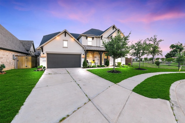 19219 Filly Park Cir, Tomball, TX 77377 - view of front facade with concrete driveway, stucco siding, a standing seam roof, an attached garage, and metal roof