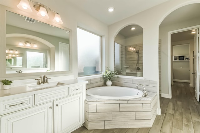 19219 Filly Park Cir, Tomball, TX 77377 - full bathroom featuring tiled shower, a bath, vanity, recessed lighting, and wood finished floors