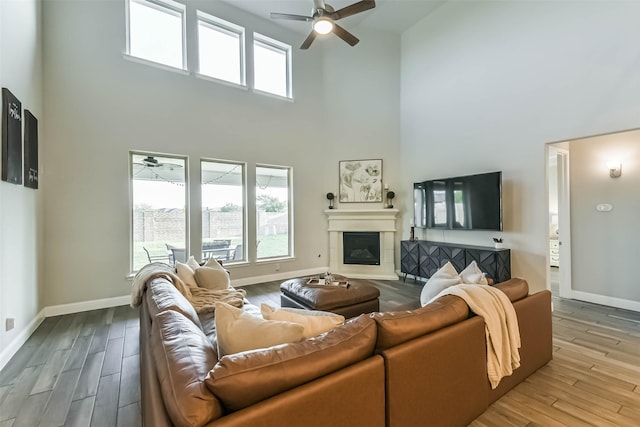 19219 Filly Park Cir, Tomball, TX 77377 - living area featuring a towering ceiling, ceiling fan, wood finished floors, and healthy amount of natural light