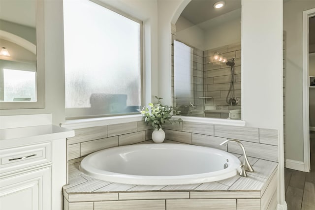 19219 Filly Park Cir, Tomball, TX 77377 - bathroom featuring a tile shower, a bath, vanity, and recessed lighting