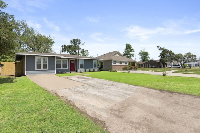 single story home featuring fence, dirt driveway, and a front yard