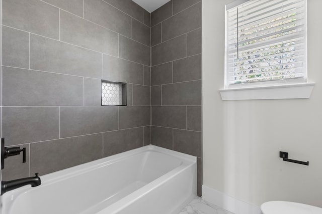 bathroom featuring baseboards, marble finish floor, and toilet