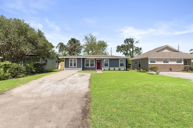 single story home featuring a front yard and concrete driveway
