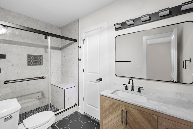bathroom featuring a shower stall, toilet, tile patterned flooring, and vanity