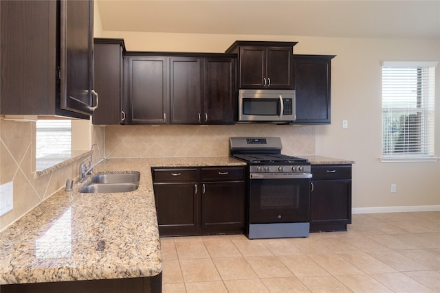 21527 Cotton Valley Ln, Porter, TX 77365 - kitchen with a wealth of natural light, decorative backsplash, stainless steel appliances, and a sink