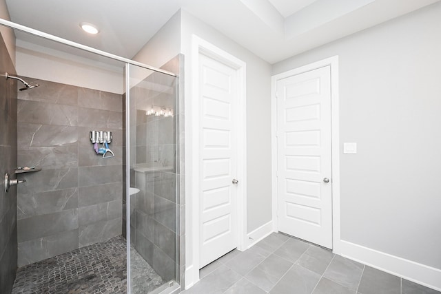bathroom featuring baseboards and a stall shower