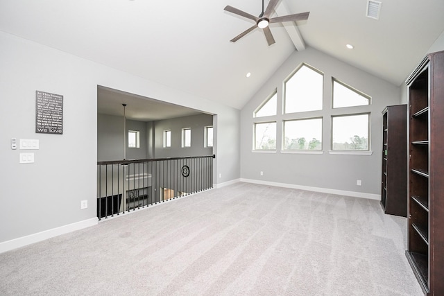 interior space featuring light colored carpet, ceiling fan, baseboards, and beam ceiling